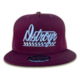 DSTROYR No Destination Long Weekend hat in maroon — front view with automotive emblem-inspired graphic